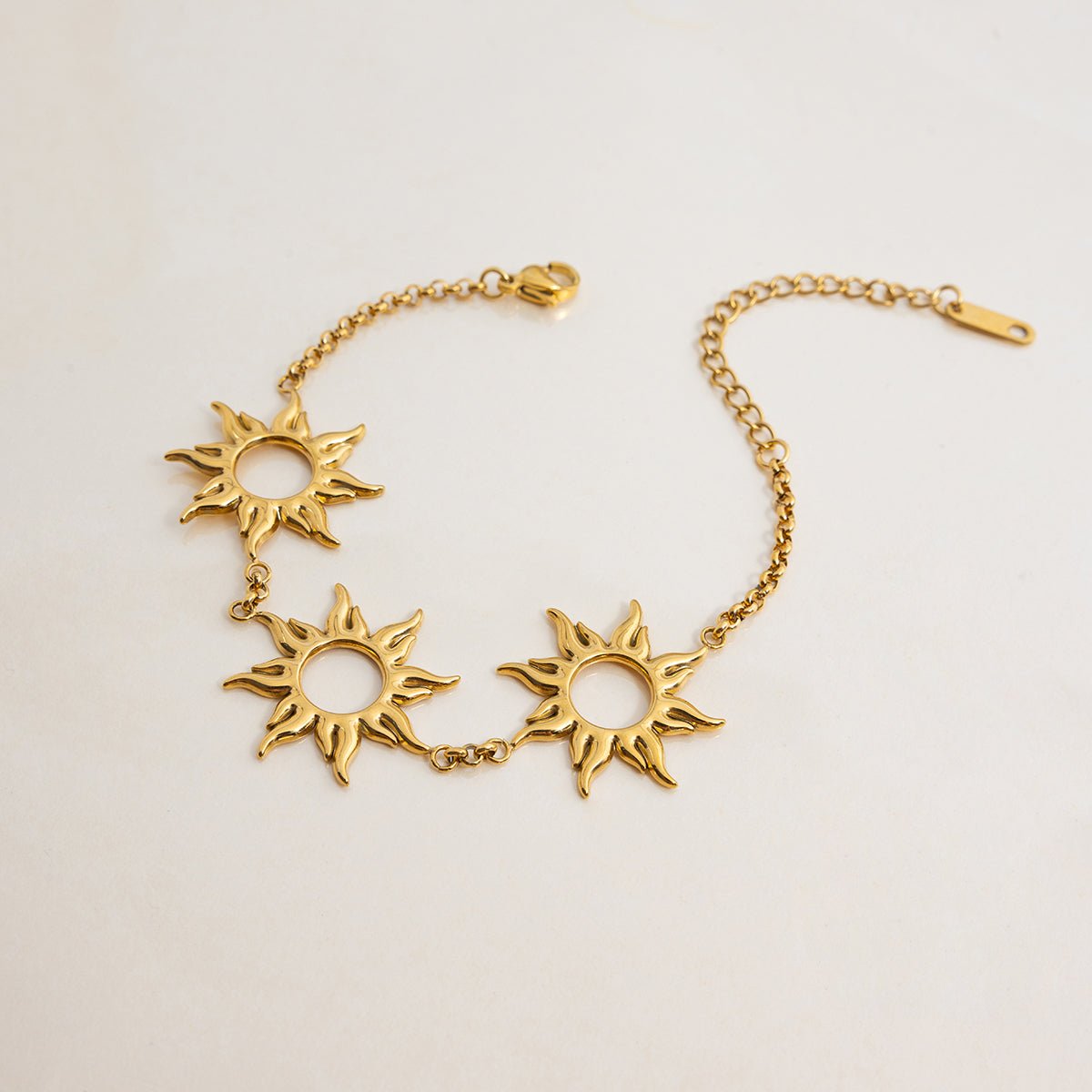 Celestial gold bracelet with radiant sun charms

