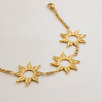 Gold sun charm bracelet with three openwork motifs

