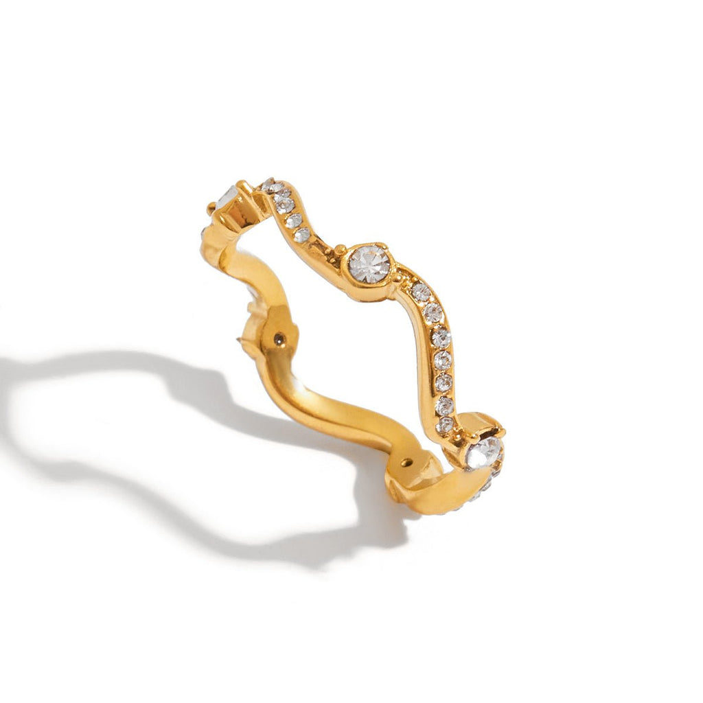 Gold Ring with clear gemstones on a white background