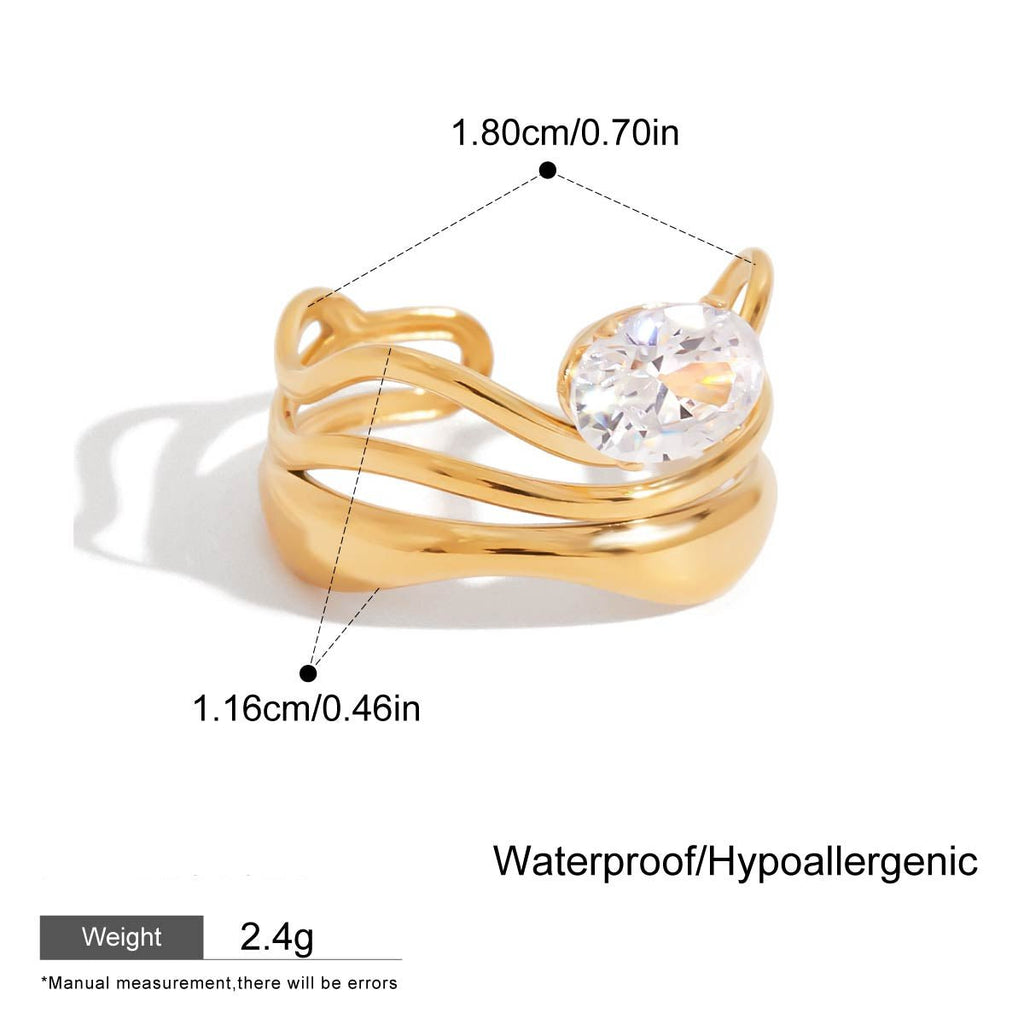 Gold ring with a clear gemstone, showing measurements and material details on a white background.