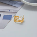 Gold ring with a diamond on a light surface