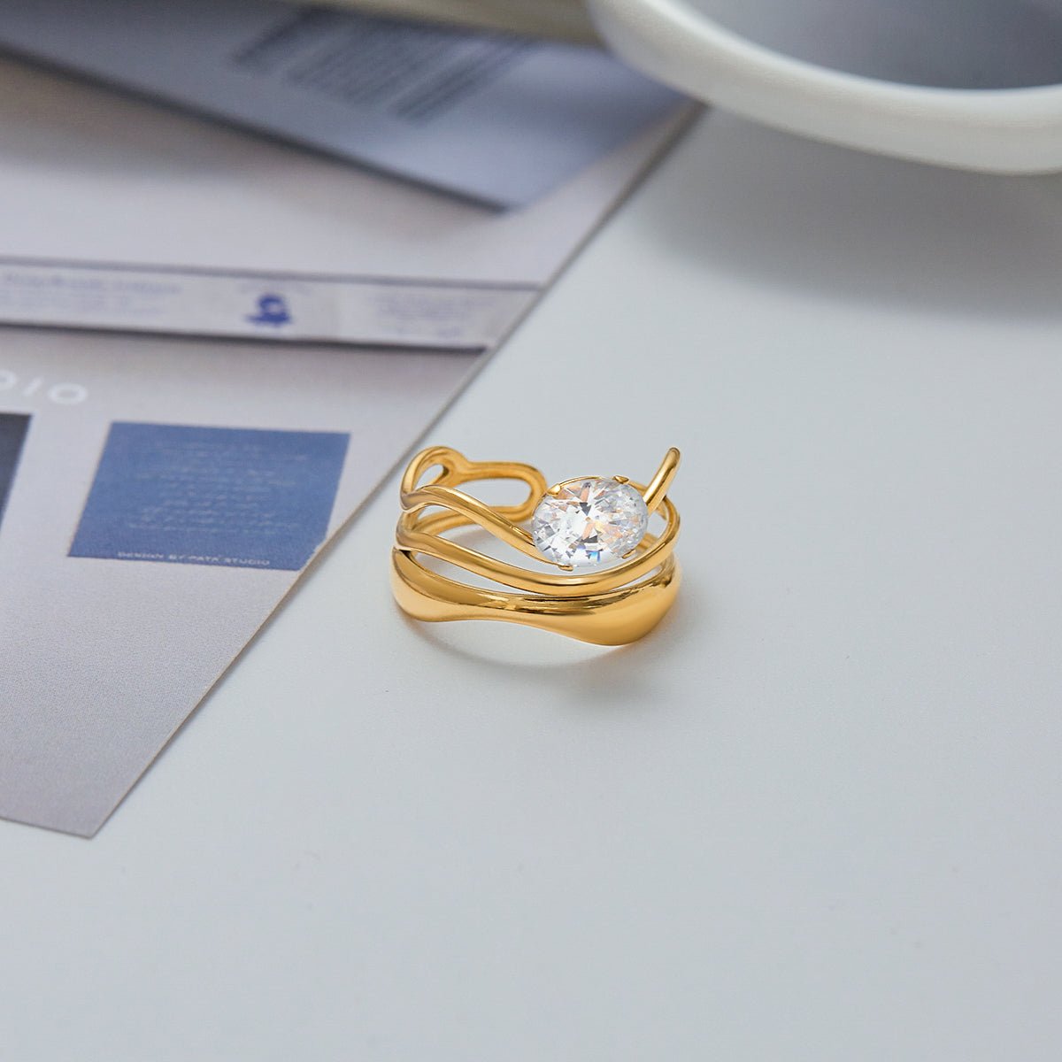 Gold ring with a diamond on a light surface