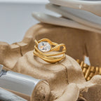 Gold ring with a diamond on a textured surface