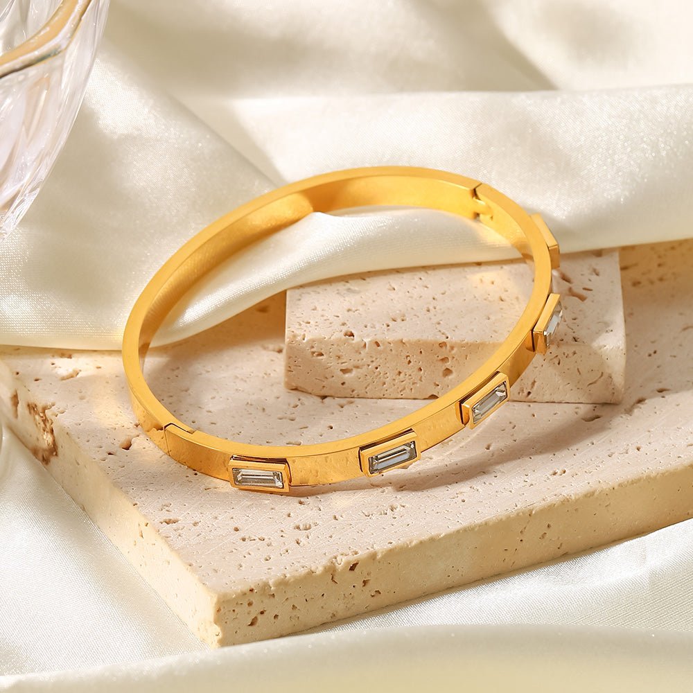Gold bangle with baguette white stones