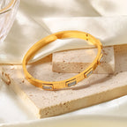 Gold bangle with baguette white stones