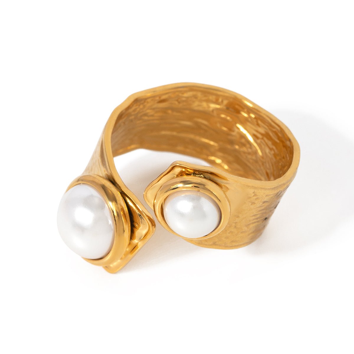 Gold ring with two pearls on a white background