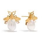 Gold bee earrings with pearl bodies on a white background