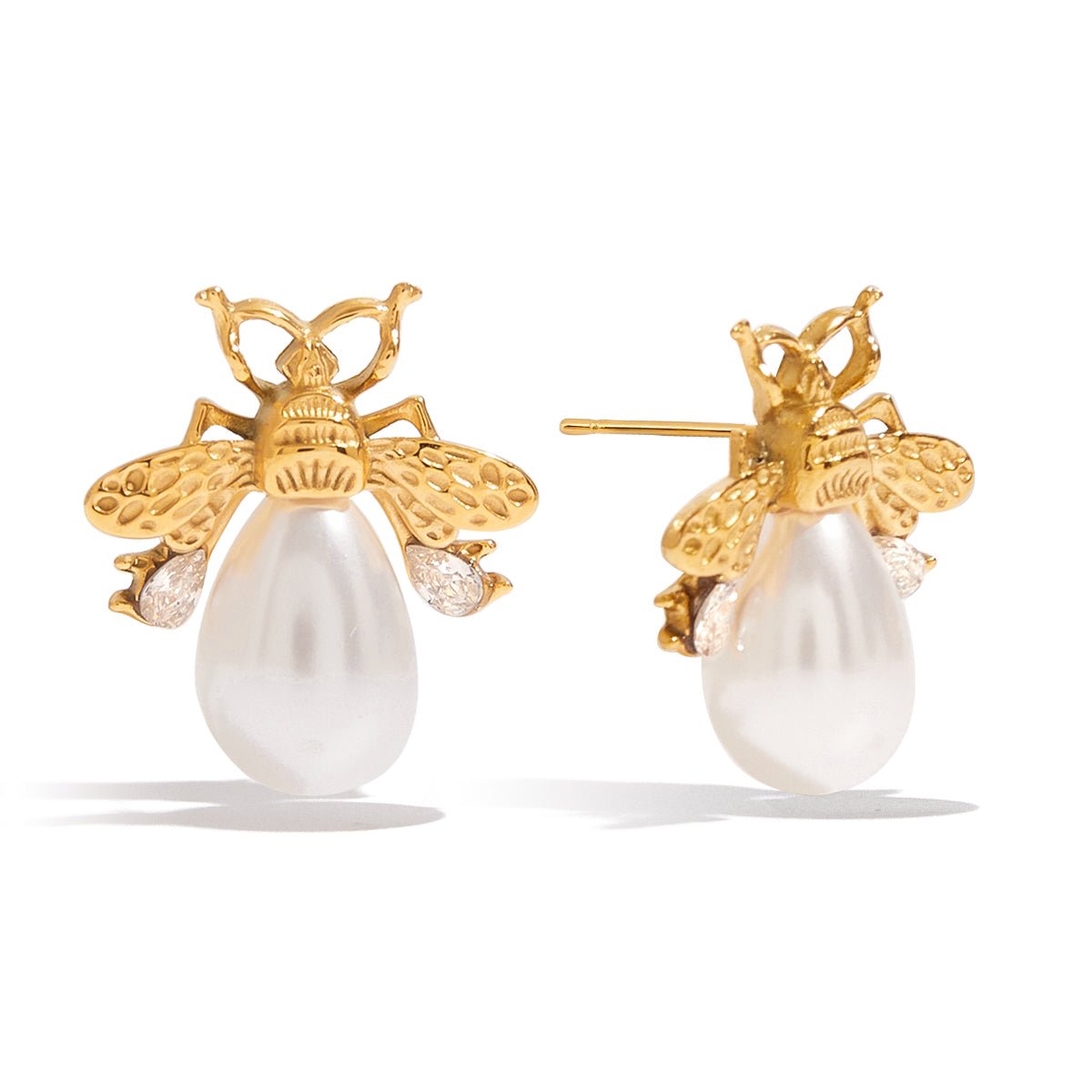 Gold bee earrings with pearl bodies on a white background