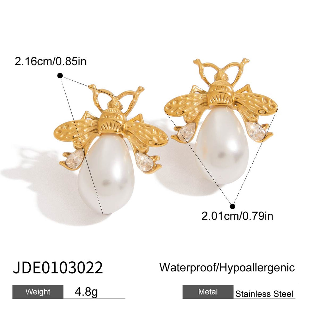 Gold and pearl earrings with measurements and product details on a white background