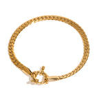 Gold braided bracelet with a clasp on a white background