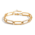 Gold chain bracelet with diamond accents on a white background