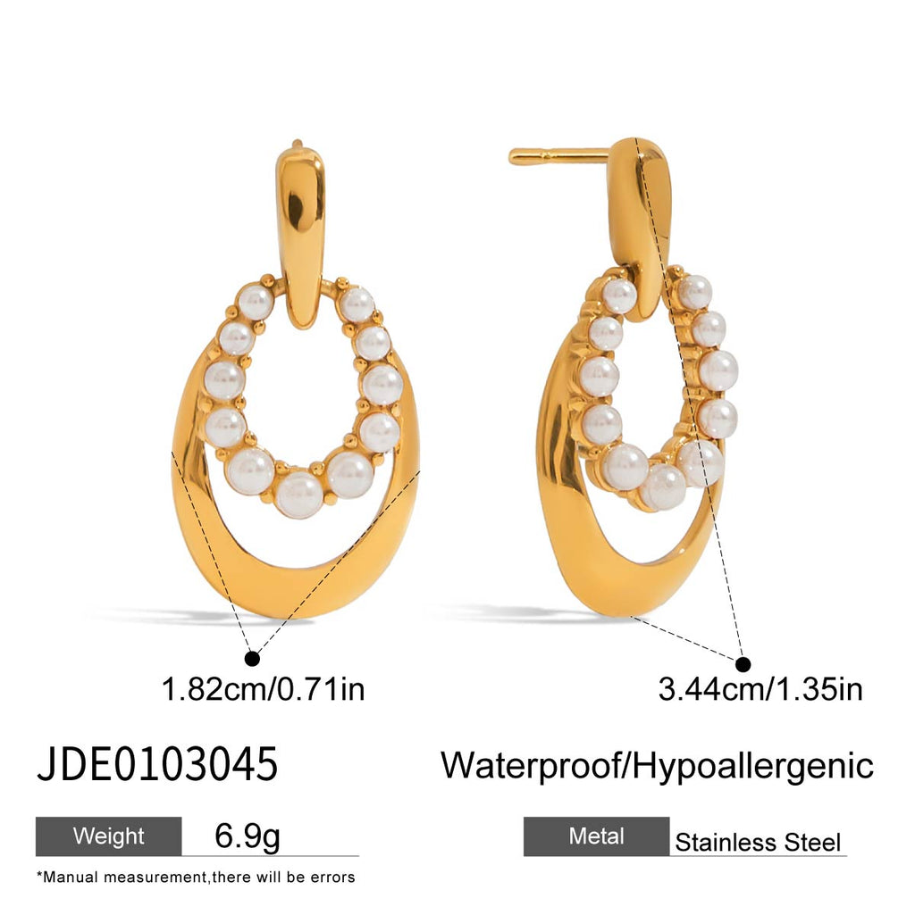 Gold hoop earrings with pearl-like beads on a white background