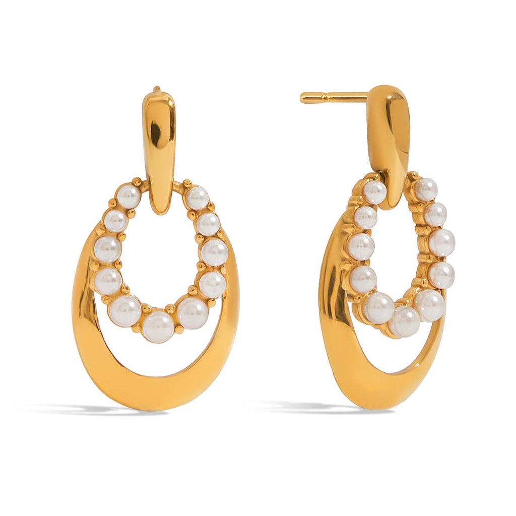 Gold hoop earrings with pearl accents on a white background