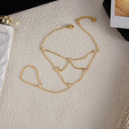 Gold chain bracelet on a mannequin bust against a neutral background