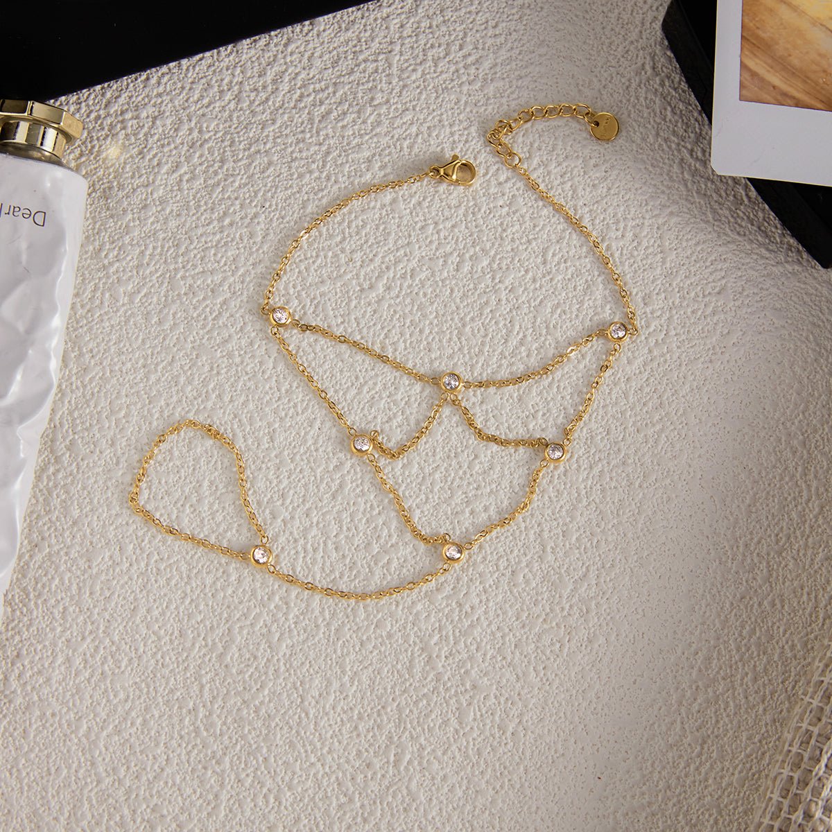 Gold chain bracelet on a mannequin bust against a neutral background