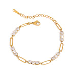 Gold bracelet with clear gemstones on a white background