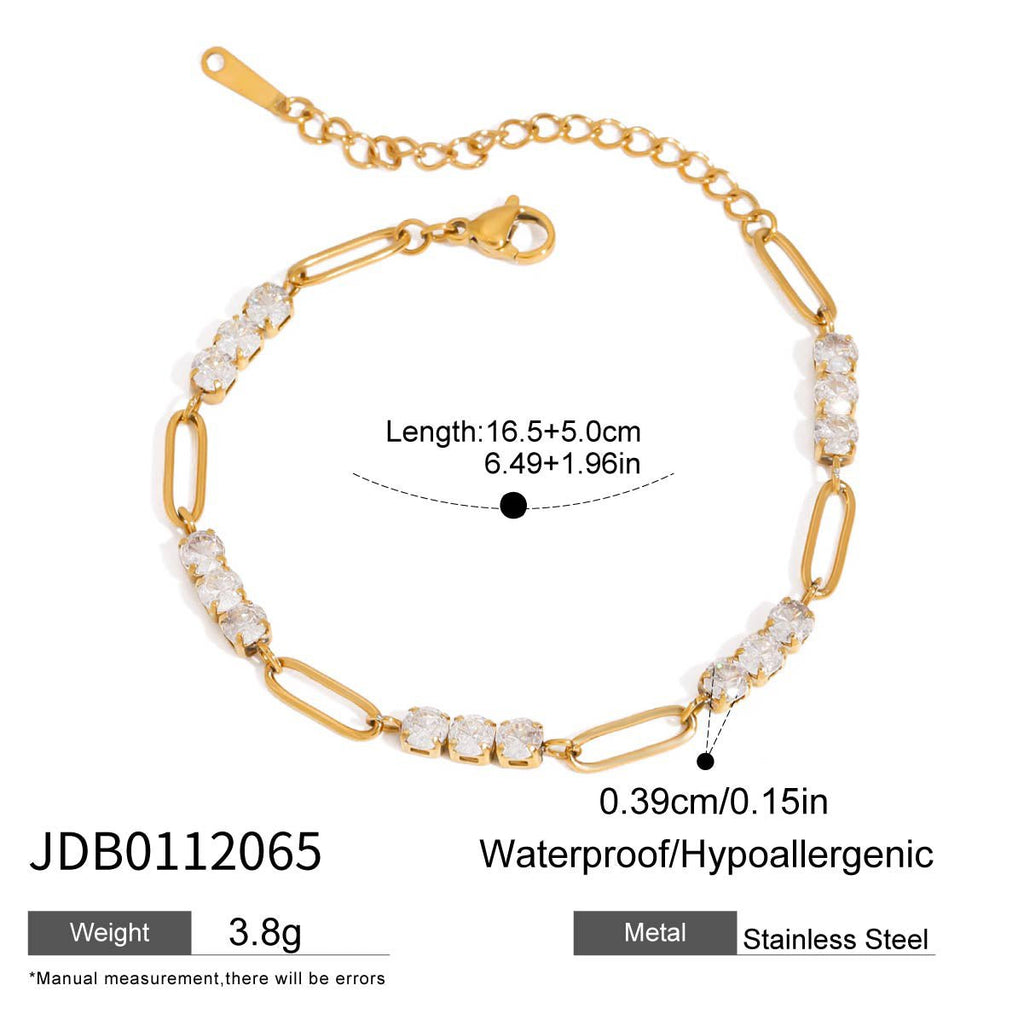 Gold bracelet with clear stones on a white background
