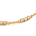 Gold bracelet with clear gemstones on a white background