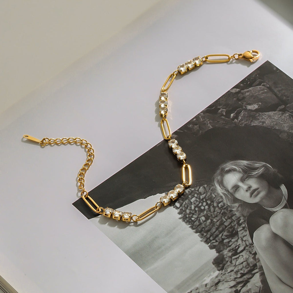 Gold chain necklace with pearls on a black and white photo background