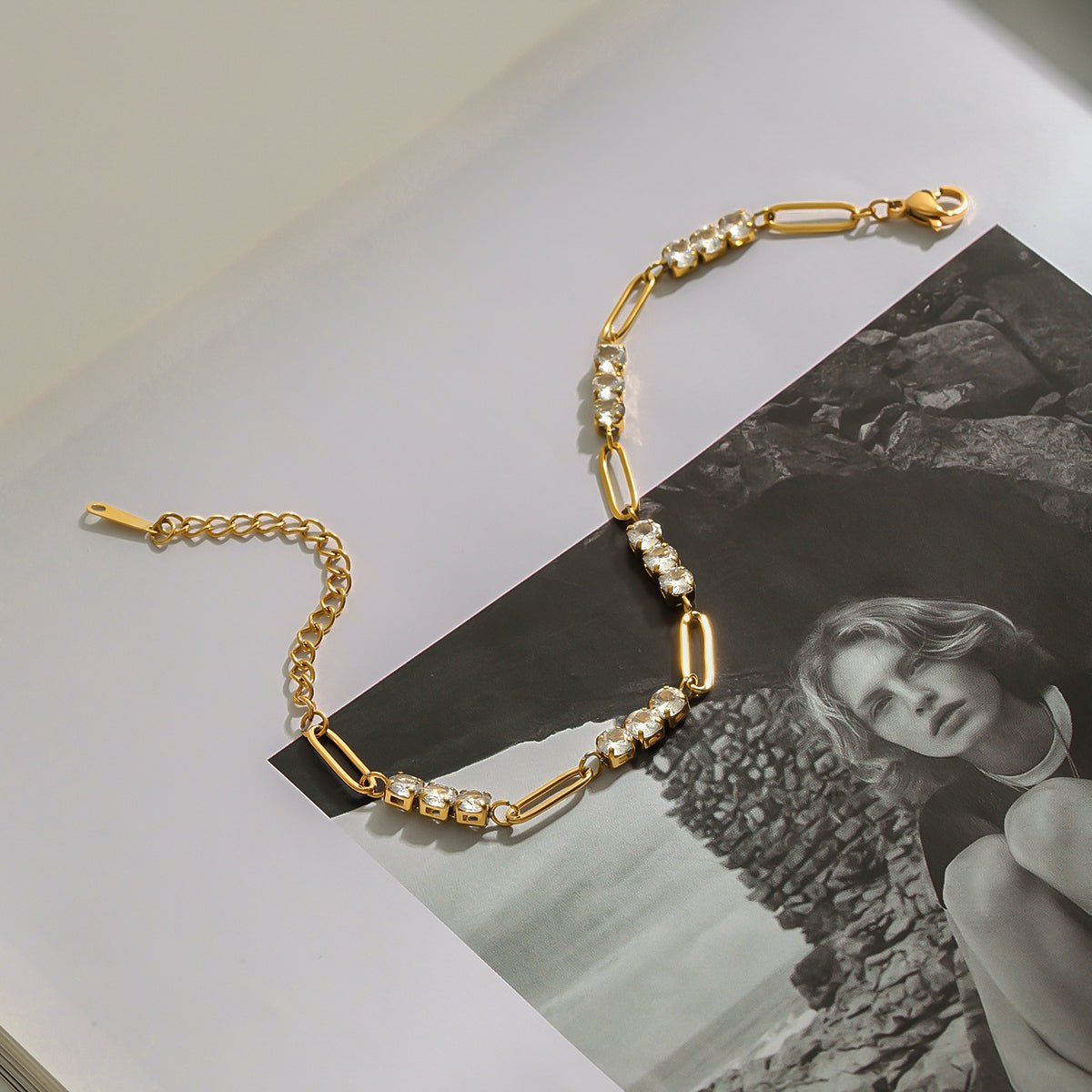 Gold chain necklace with pearls on a black and white photo background