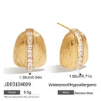 Gold earrings with clear stones on a white background