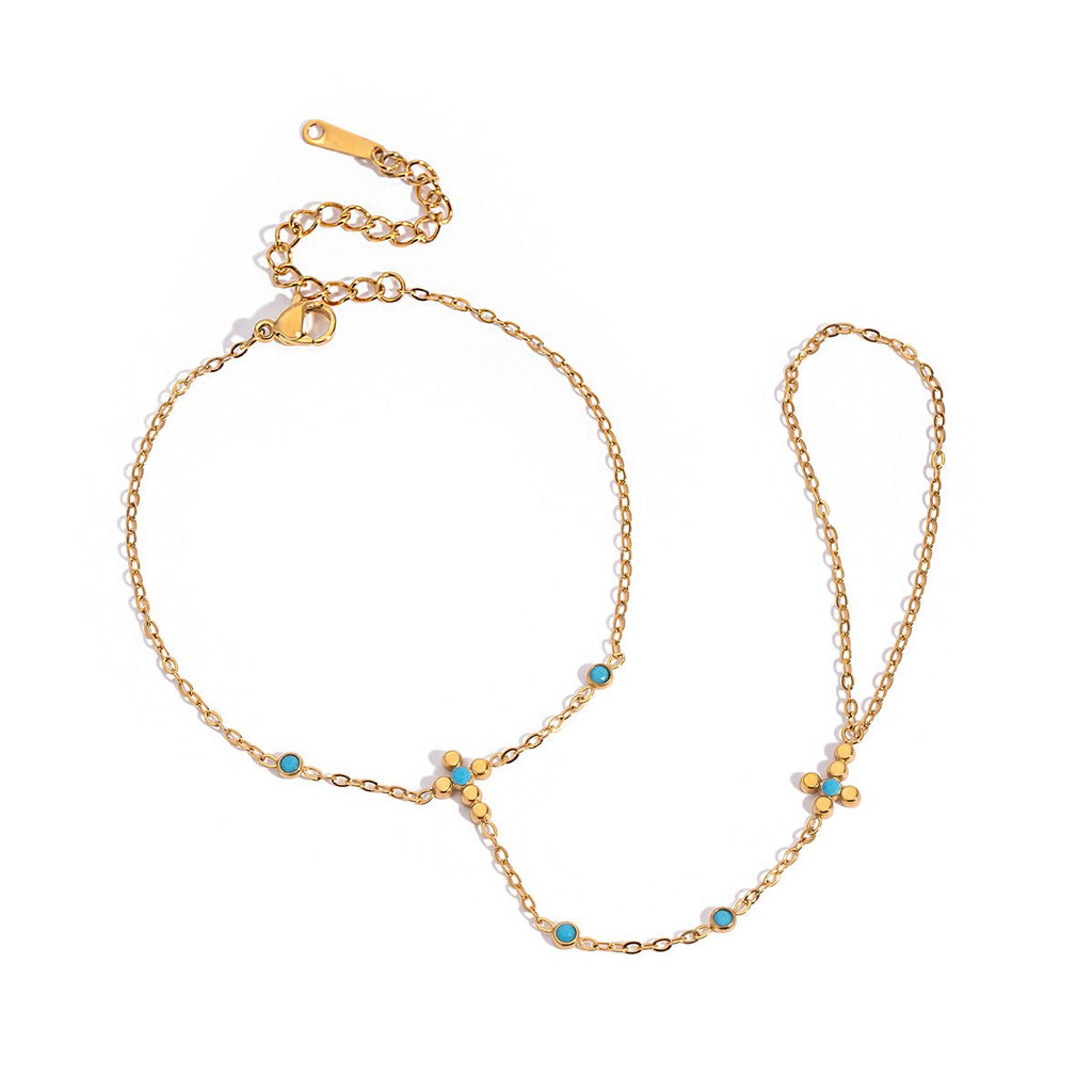 Gold necklace with turquoise stones on a white background