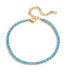 Turquoise beaded bracelet with gold clasp on a white background