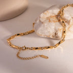 Gold bracelet on a textured surface with a neutral background