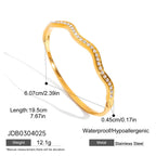 Gold bracelet with diamond-like stones and measurement details on a white background