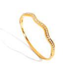 Gold bracelet with small diamonds on a white background