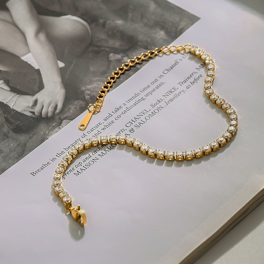 Gold and pearl bracelet on an open book