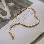 Gold and pearl bracelet on an open book