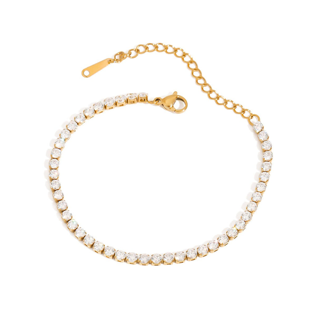 Gold bracelet with clear stones on a white background