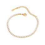 Gold bracelet with clear stones on a white background