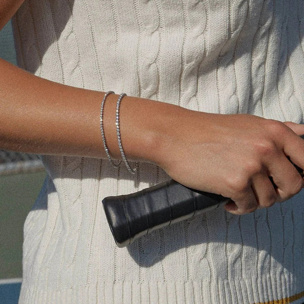 Person holding a black clutch with a blurred background