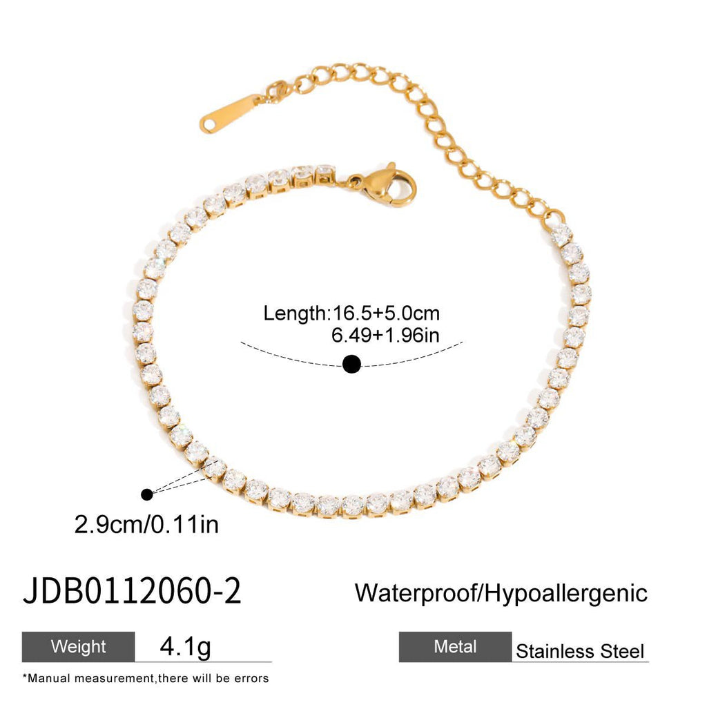 Gold bracelet with pearl-like beads on a white background