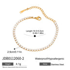 Gold bracelet with pearl-like beads on a white background