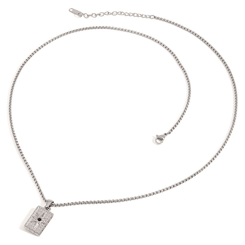 Silver necklace with a rectangular pendant on a white background