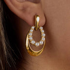 Pearlétique sculptural oval drop earrings featuring 18k gold PVD plating and pearls.