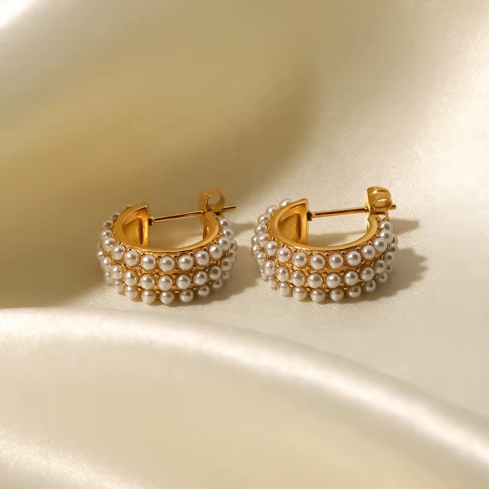 Waterproof gold pearl hoop earrings for swimming and active lifestyles.