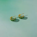 The Windsor Emerald hoop earrings in 18k gold PVD plated stainless steel.
