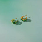 The Windsor Emerald hoop earrings in 18k gold PVD plated stainless steel.

