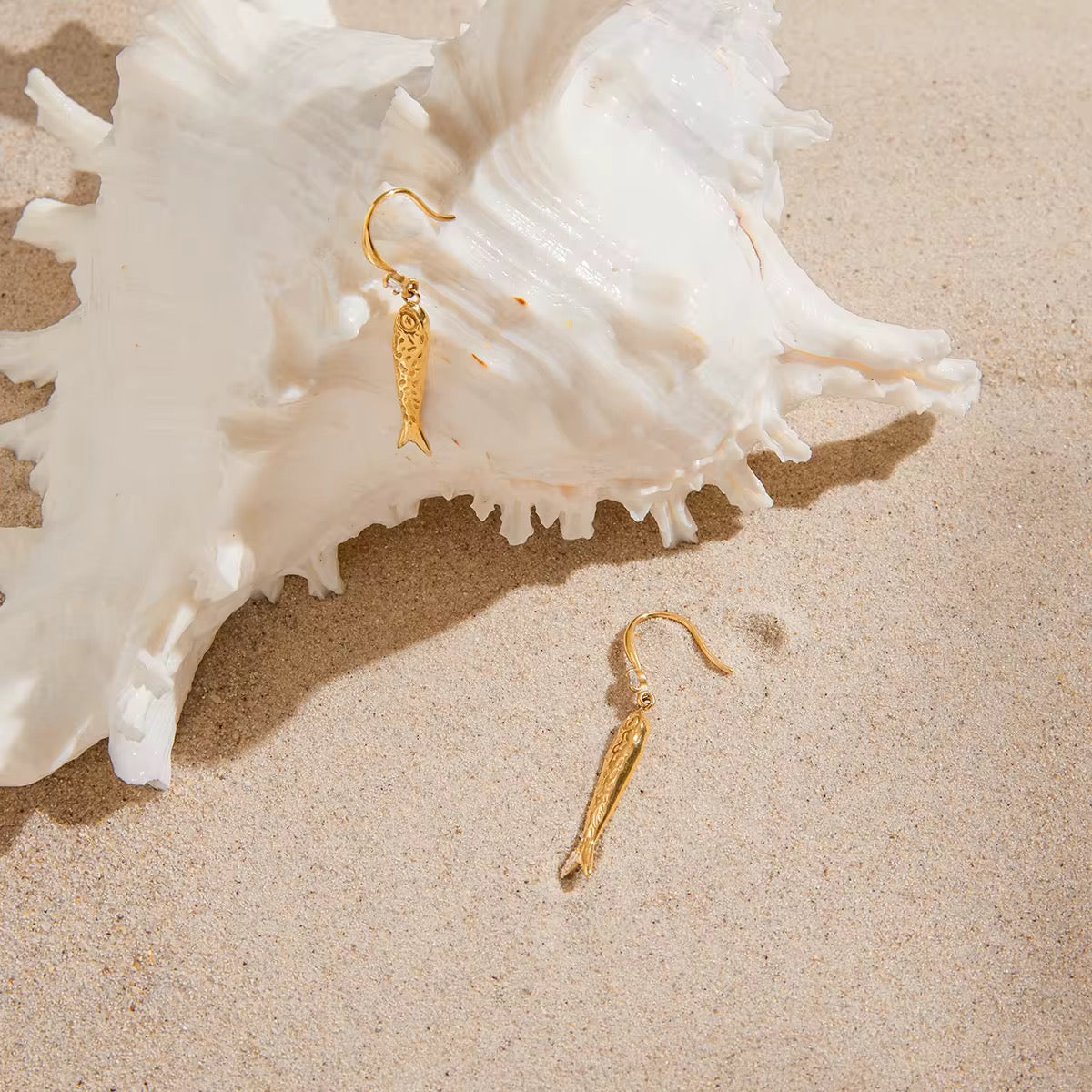 Waterproof gold fish drop earrings with sparkling crystal eye details.