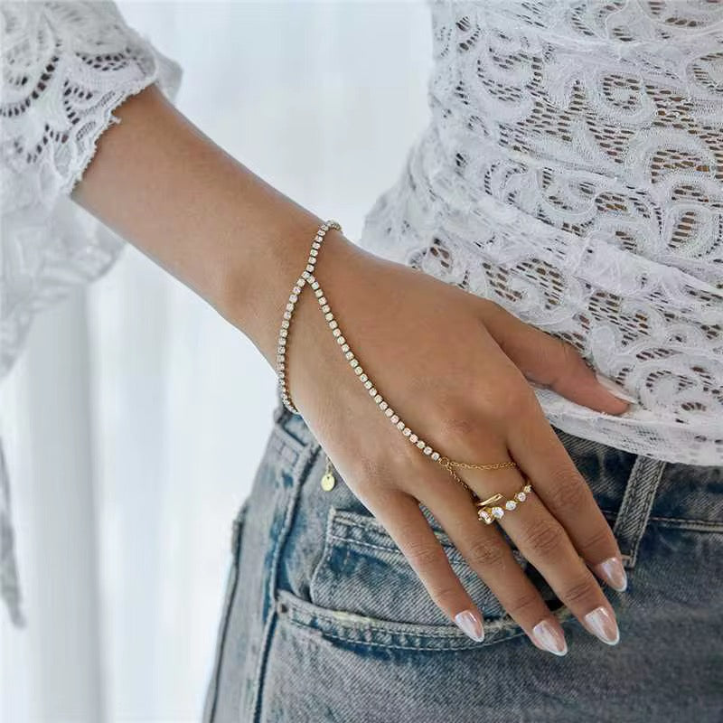 The Tiara hand chain featuring 18k gold PVD plated stainless steel and clear crystals.