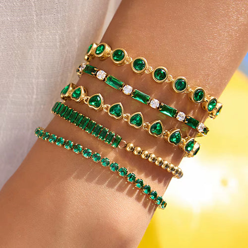 Emerald Theory green tennis bracelet in 18k gold PVD plated stainless steel.
