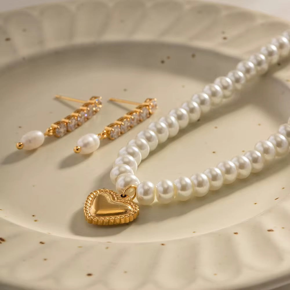Waterproof The Pearl Strand gold necklace with etched floral heart charm.