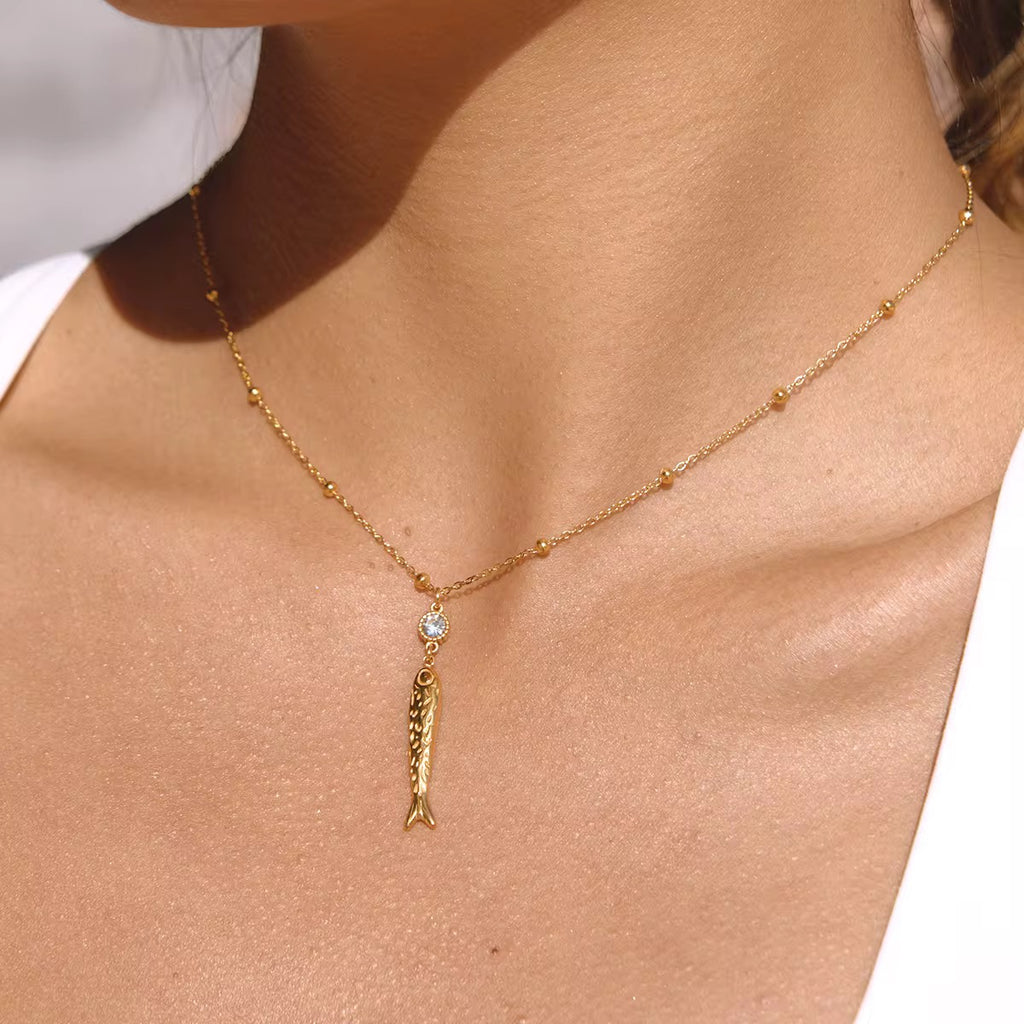 Very Fishy Indeed necklace with 18k gold PVD plated fish pendant and bead chain.
