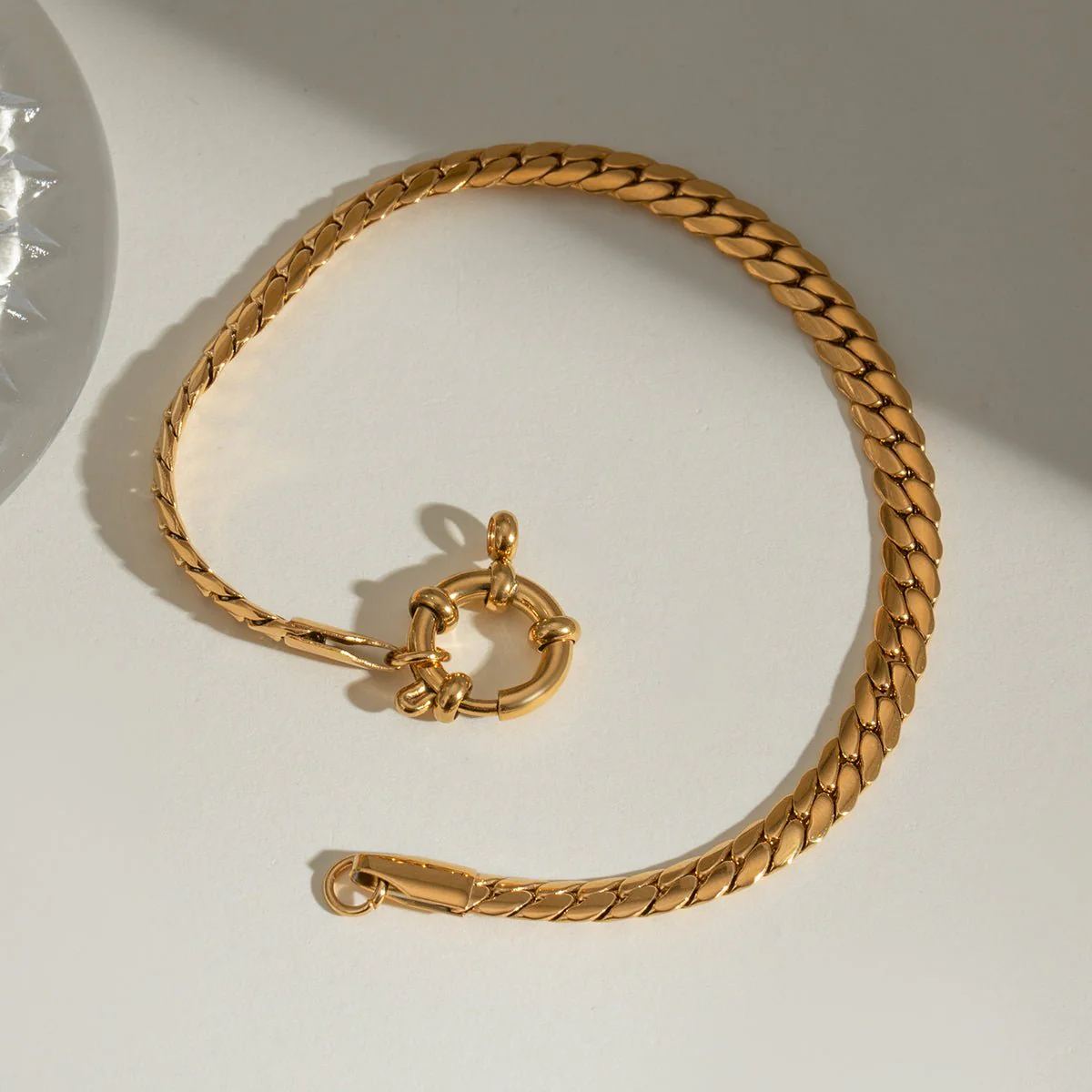 The Foundry Coil flat curb chain bracelet in 18k gold PVD plated stainless steel.
