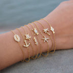 Waterproof gold sea creature bracelet for swimming and active coastal lifestyles.