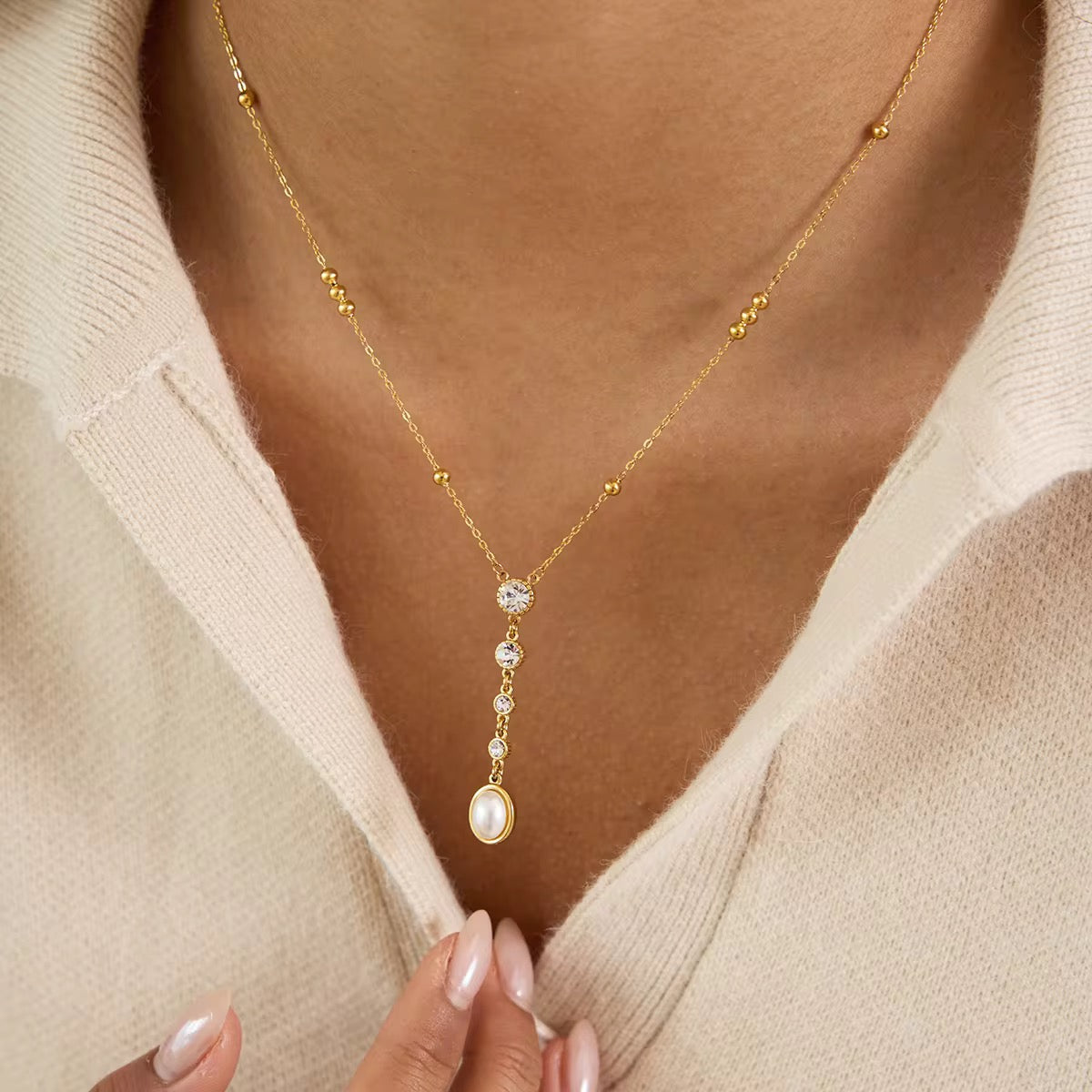 Ritz Cascade lariat necklace featuring 18k gold PVD plated stainless steel and a pearl drop.